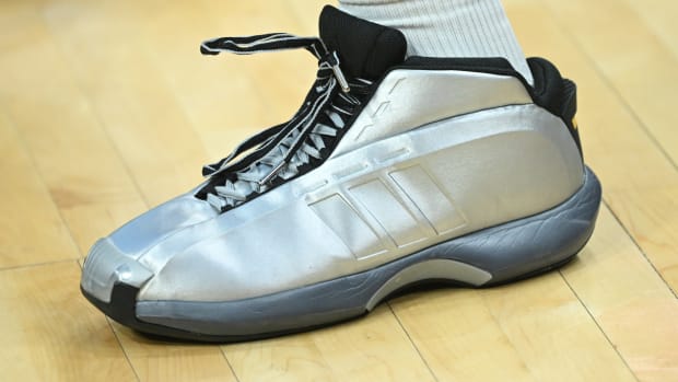 View of silver and black Adidas shoes.